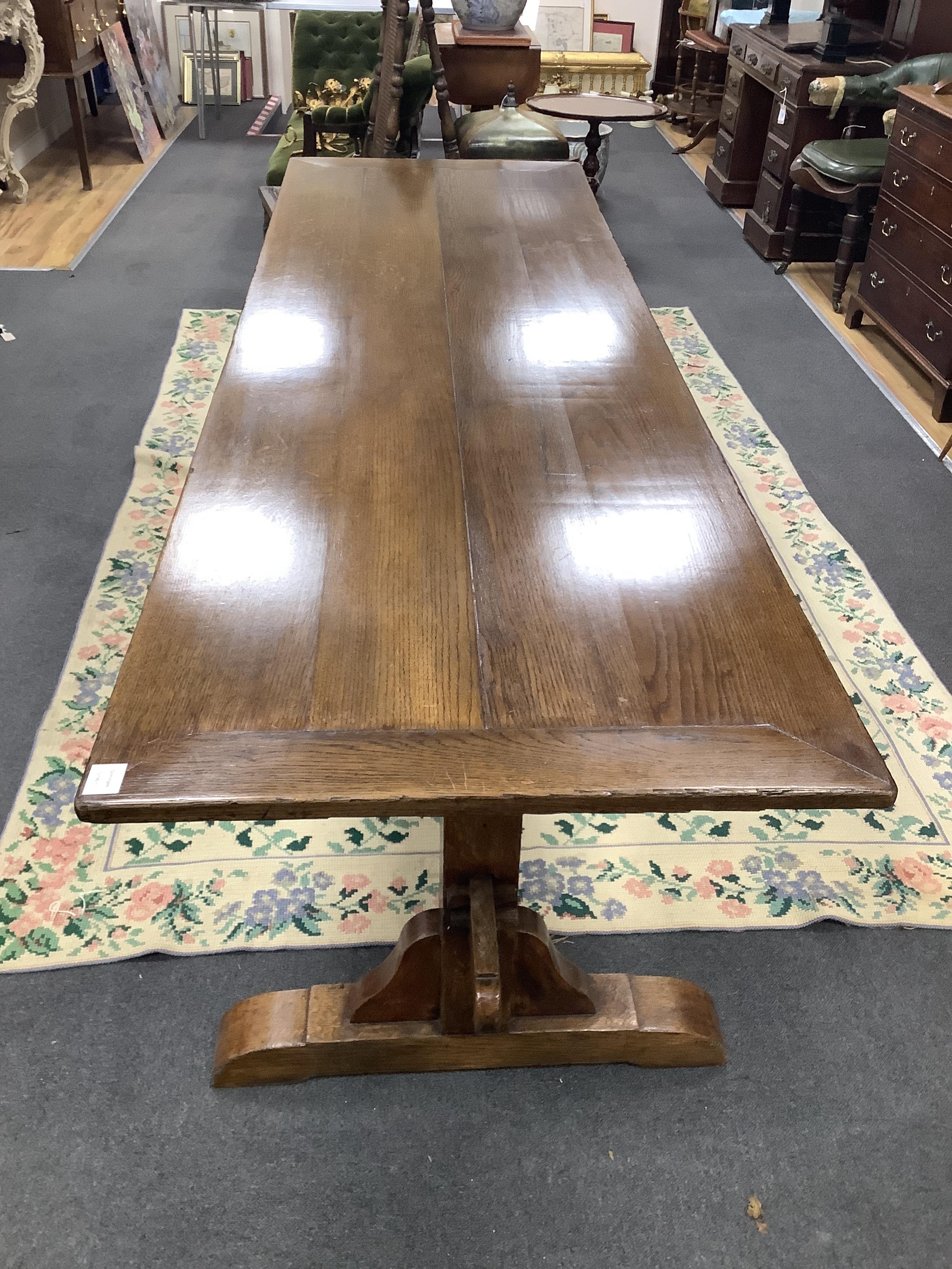 An 18th century style rectangular oak refectory style dining table, length 244cm, width 76cm, height 76cm
